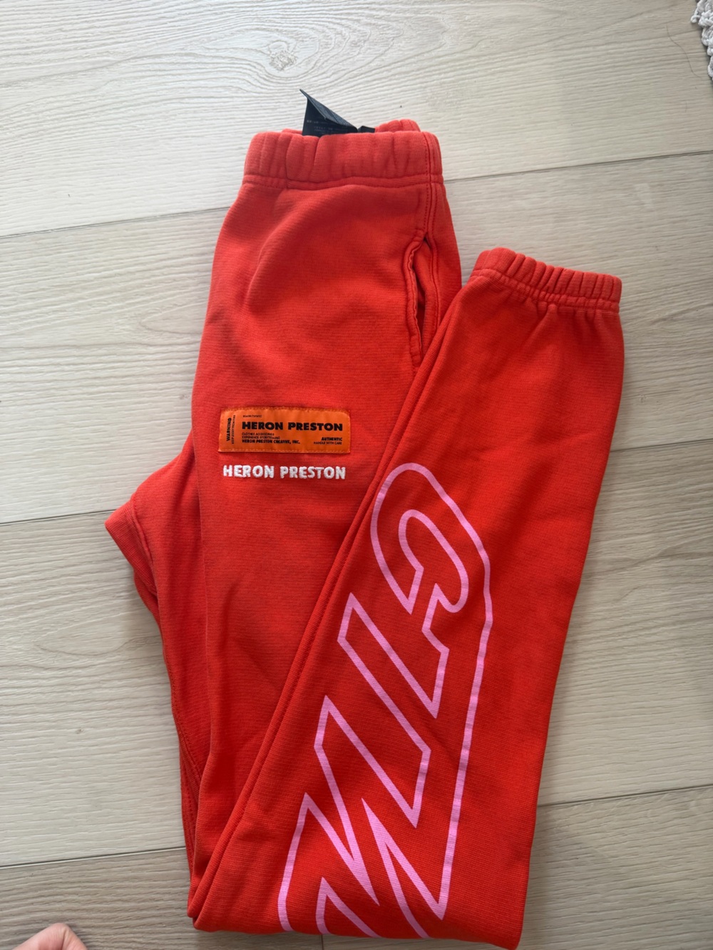 Heron Preston Women’s Orange Sweatpants with Pink Graphic
